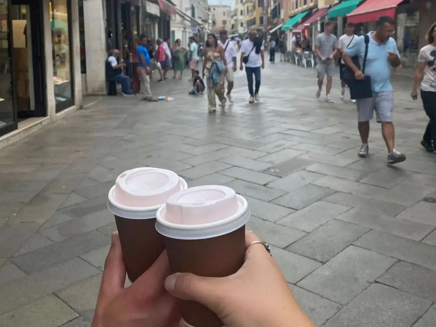 Walking down the street with coffee.