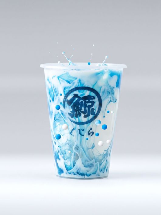 Blue iced drink in a clear cup with splashing liquid on a light gray background