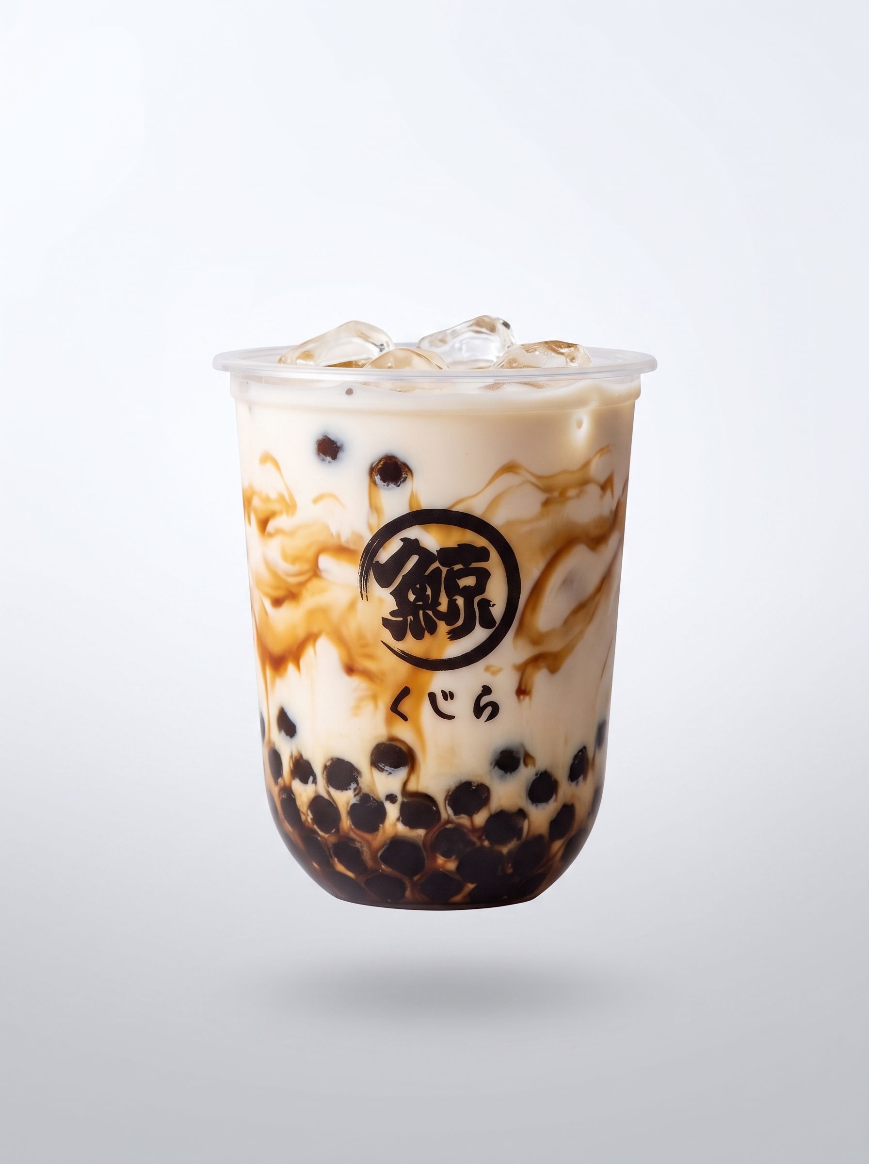 Iced milk tea with tapioca pearls and caramel swirls in a clear plastic cup