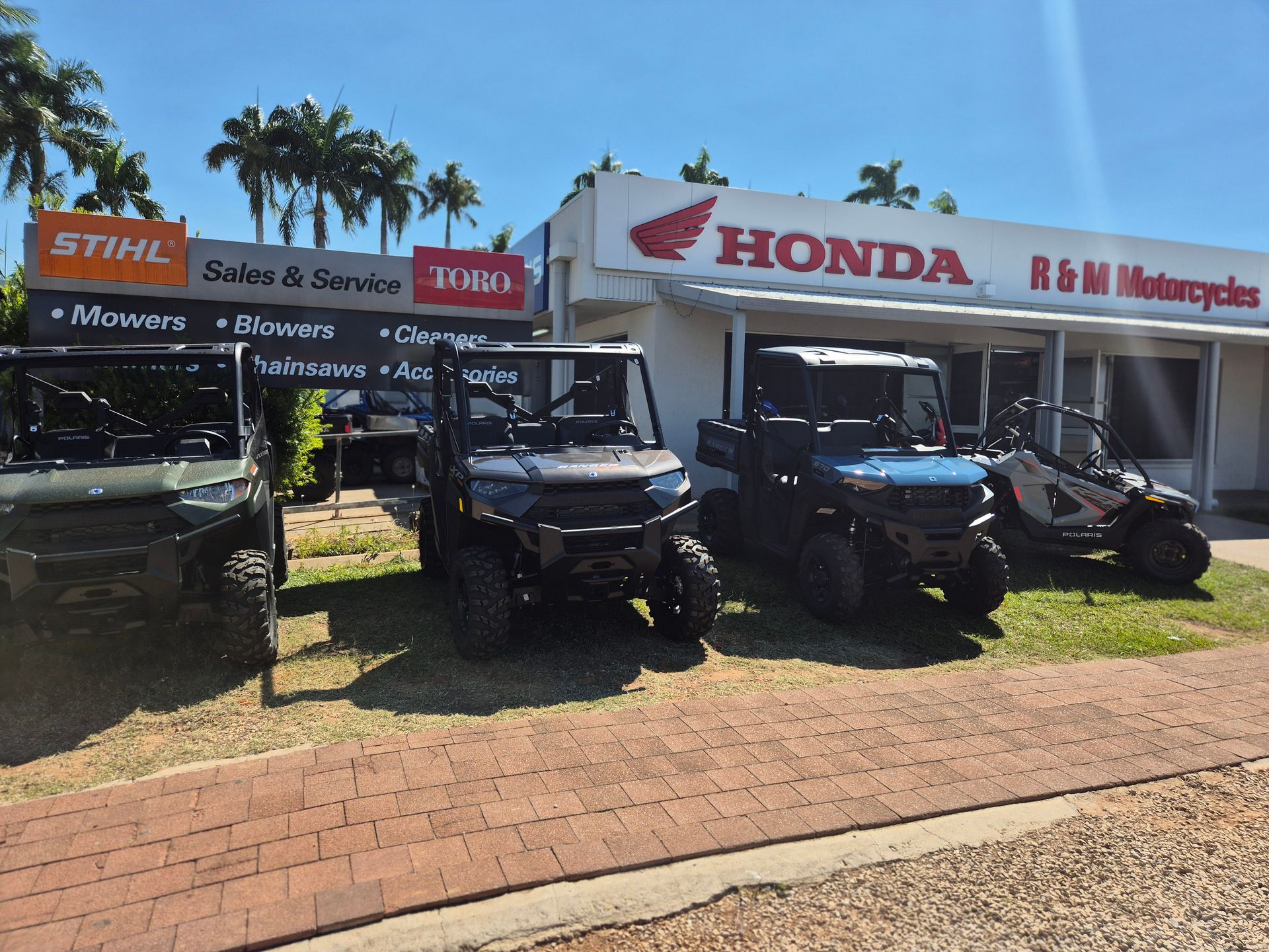 A Red and Black ATV is Parked in Front of a R & M Motorcycles Store 	— R & M Motorcycles in Katherine, NT