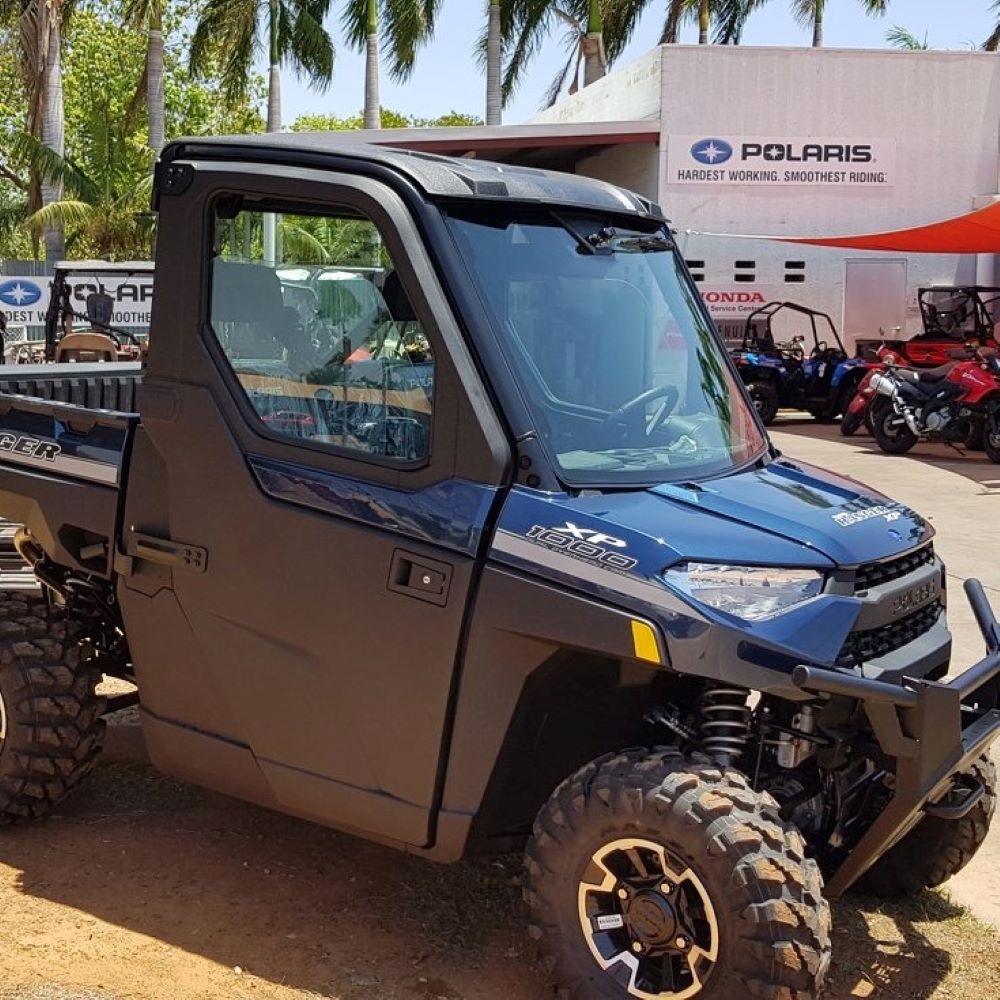 A Blue and Black Polaris Utility Vehicle is Parked in Front of a Dealership — R & M Motorcycles in Katherine, NT