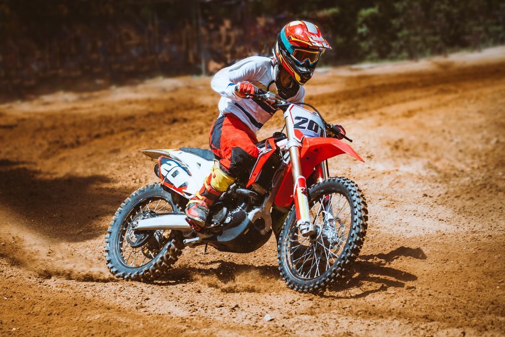 A Person is Riding a Dirt Bike on a Dirt Track — R & M Motorcycles in Katherine, NT