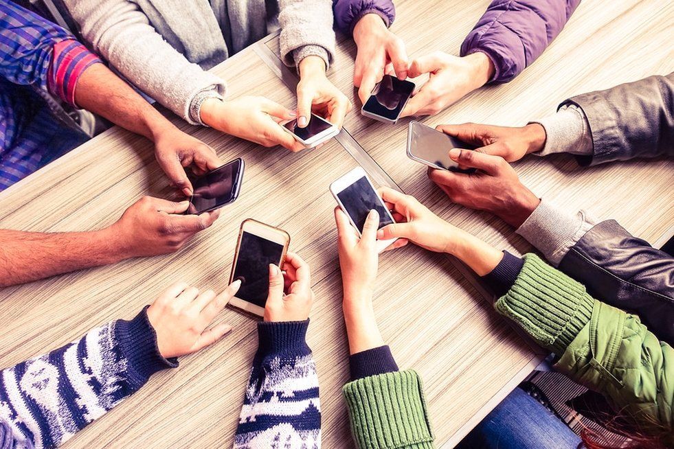 Multiple people on their cellphones