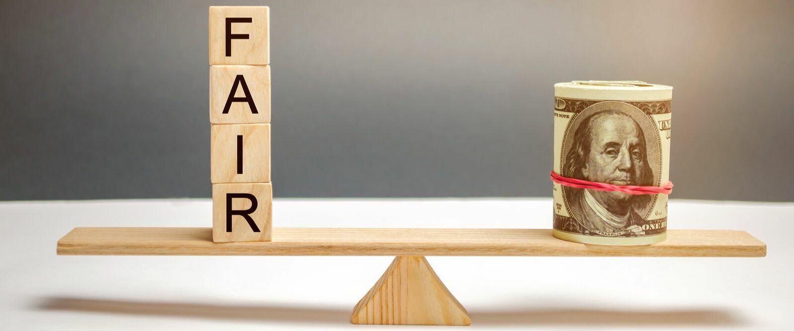 Scales balanced between money and fairness