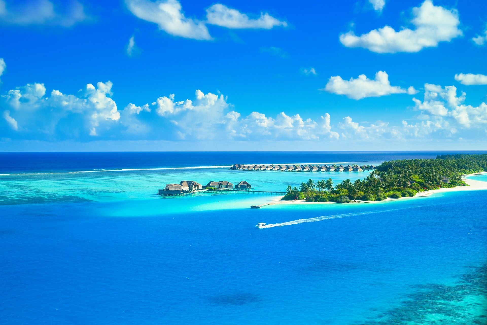 An aerial view of a tropical island in the middle of the ocean.