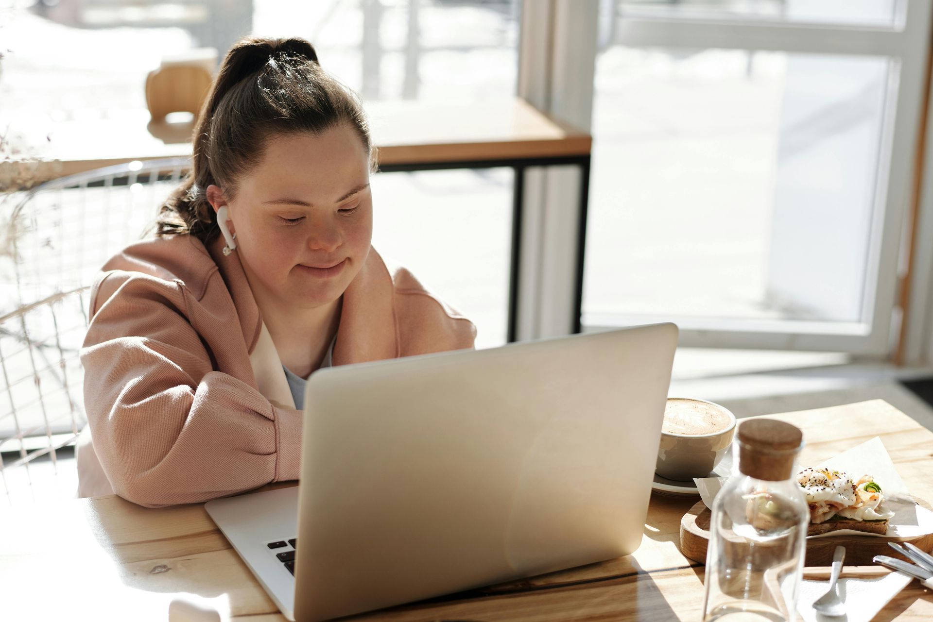 A girl is having a telemedicine consult on a laptop