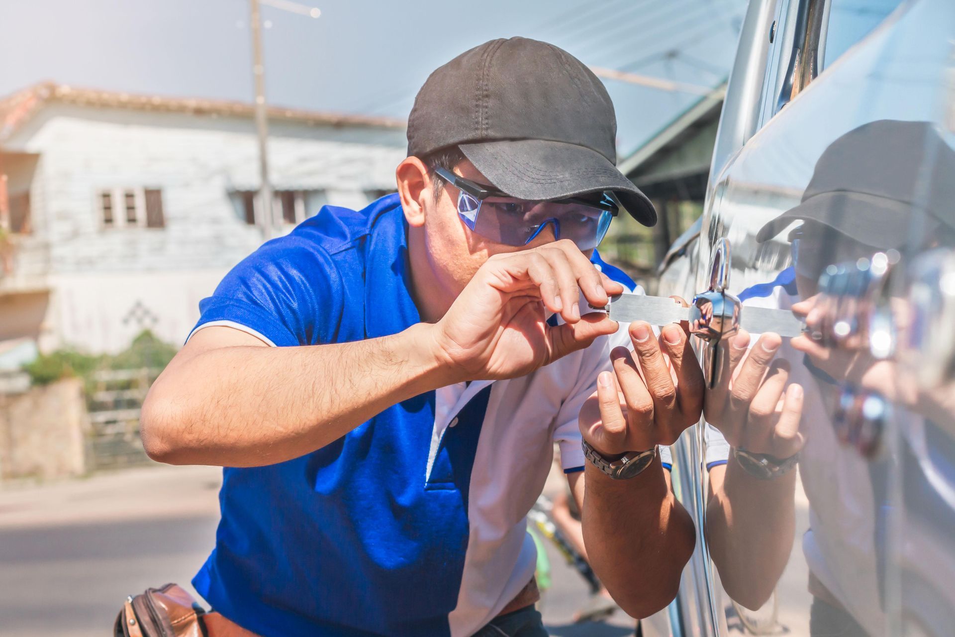 a man is using a key to open a car door .