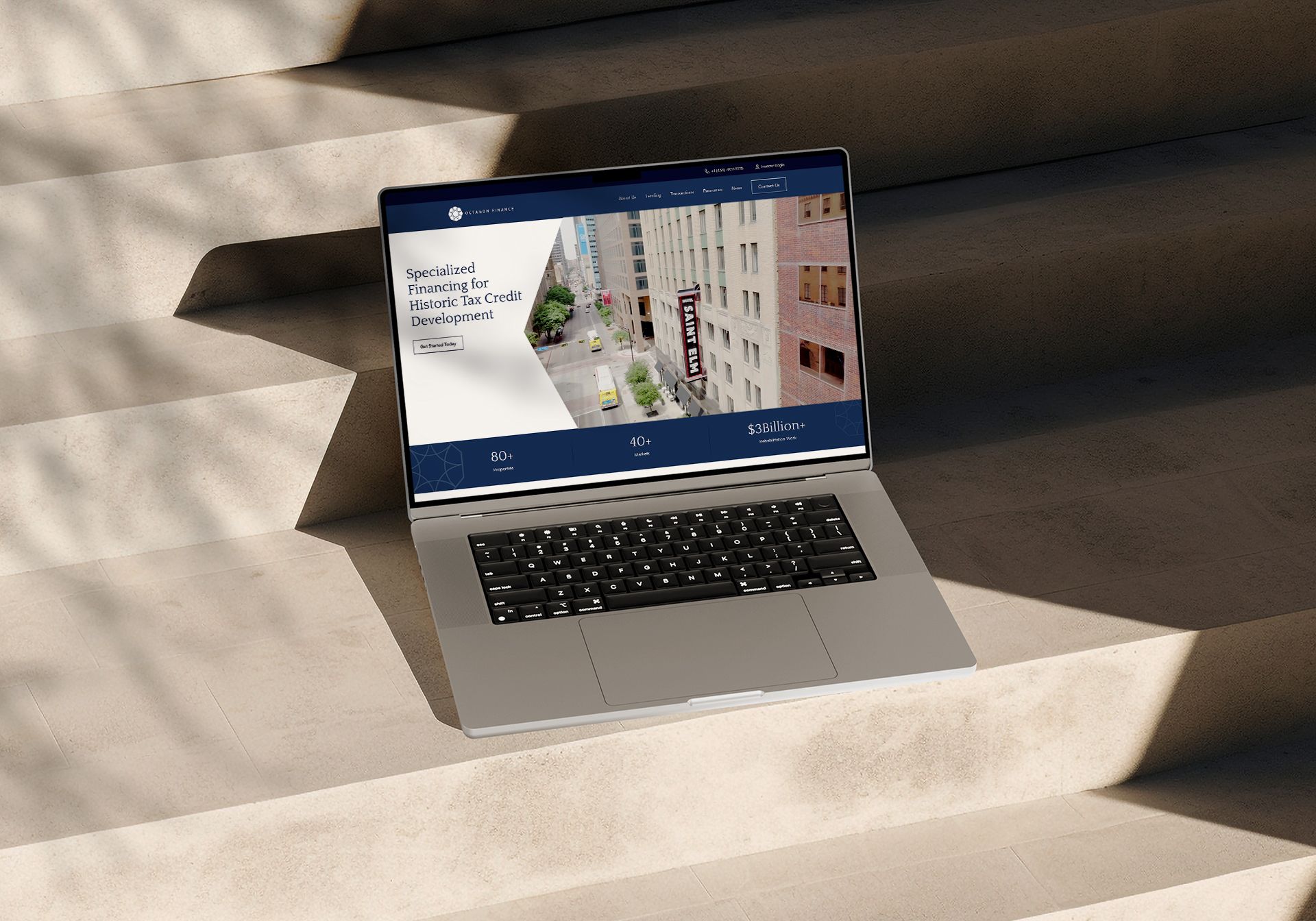 Laptop displaying website on outdoor steps.