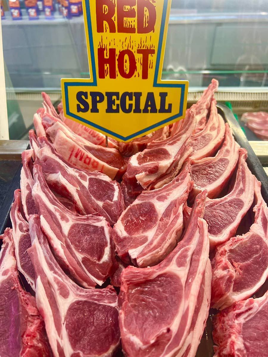 Tray Of Lamb Chops With A Sign That Says Red Hot Special — Elite Meats in Holt, ACT