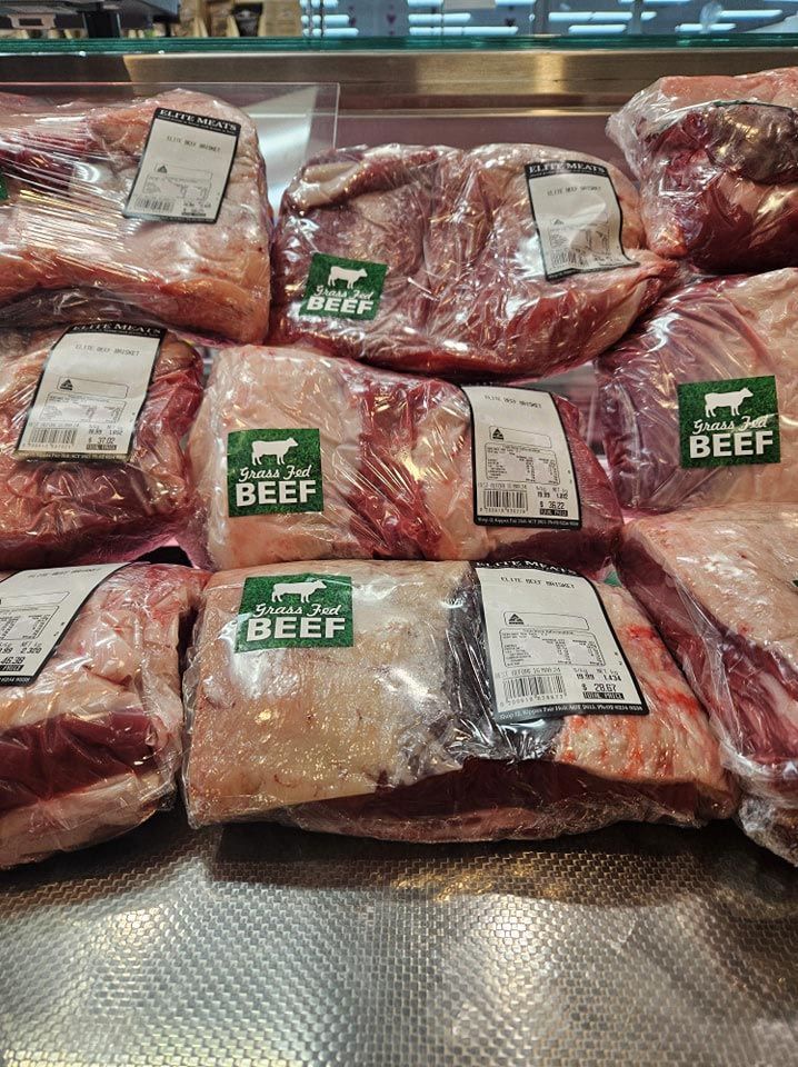 A bunch of bags of beef are sitting on top of each other on a counter.