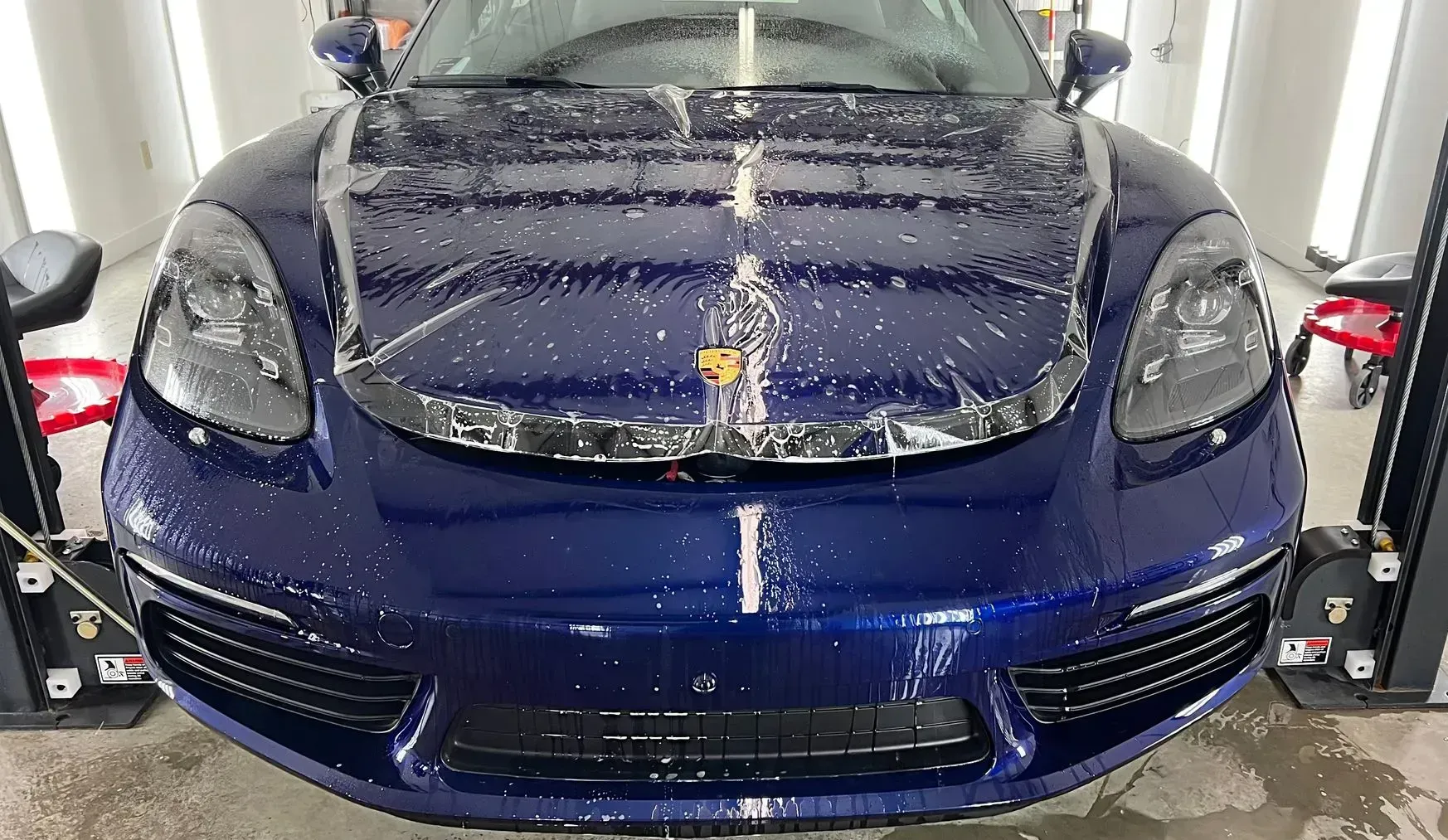 professional paint protection film installation on blue vehicle