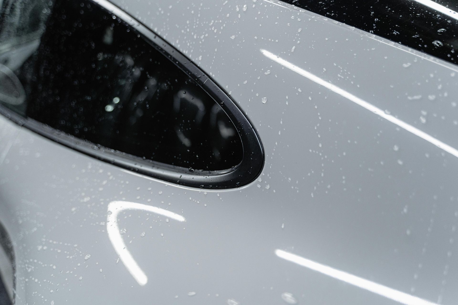 Car with glossy finish shows water beading after Automotive Ceramic Coating application.