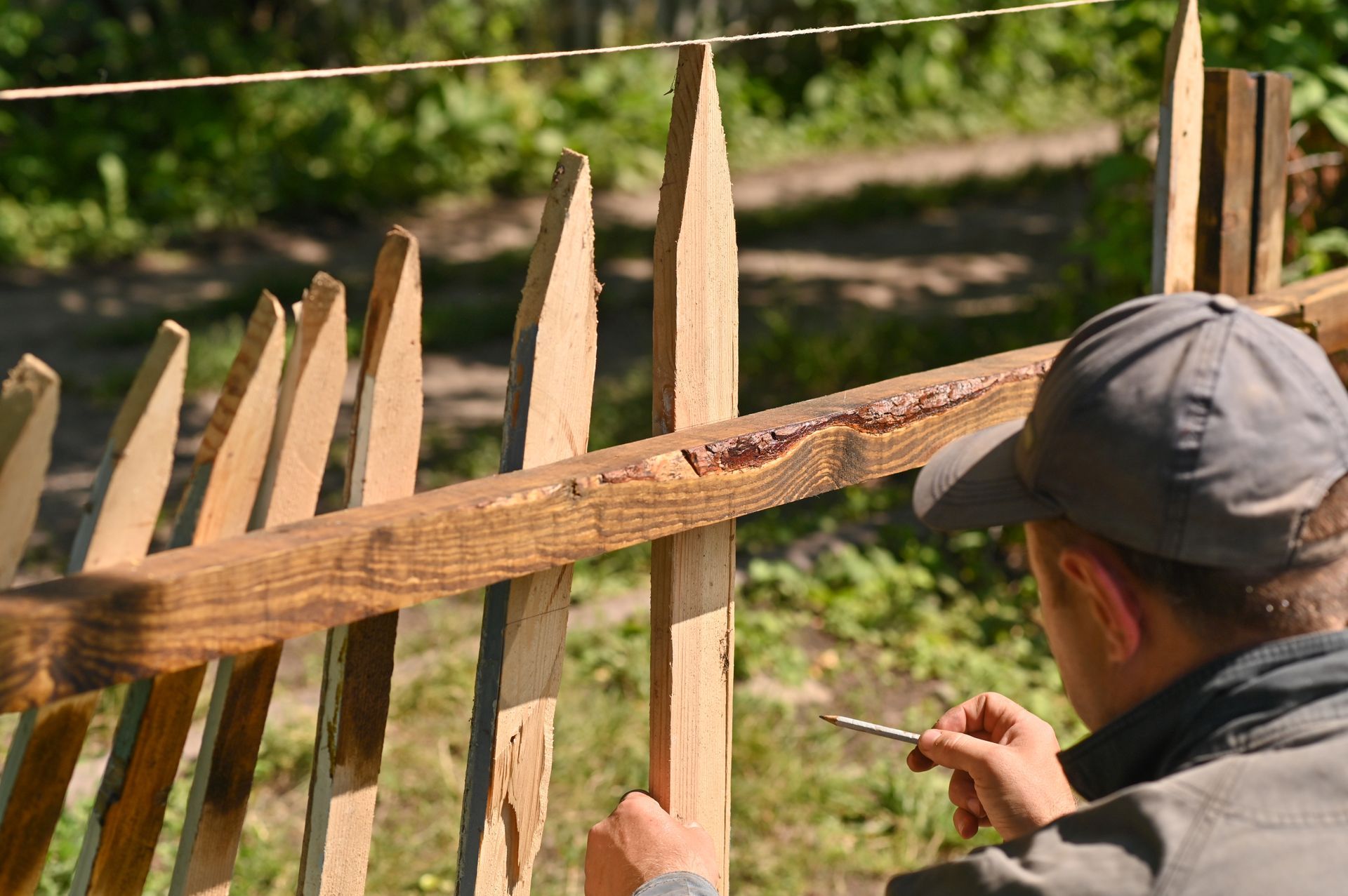 worker repairing wooden fence in Buffalo