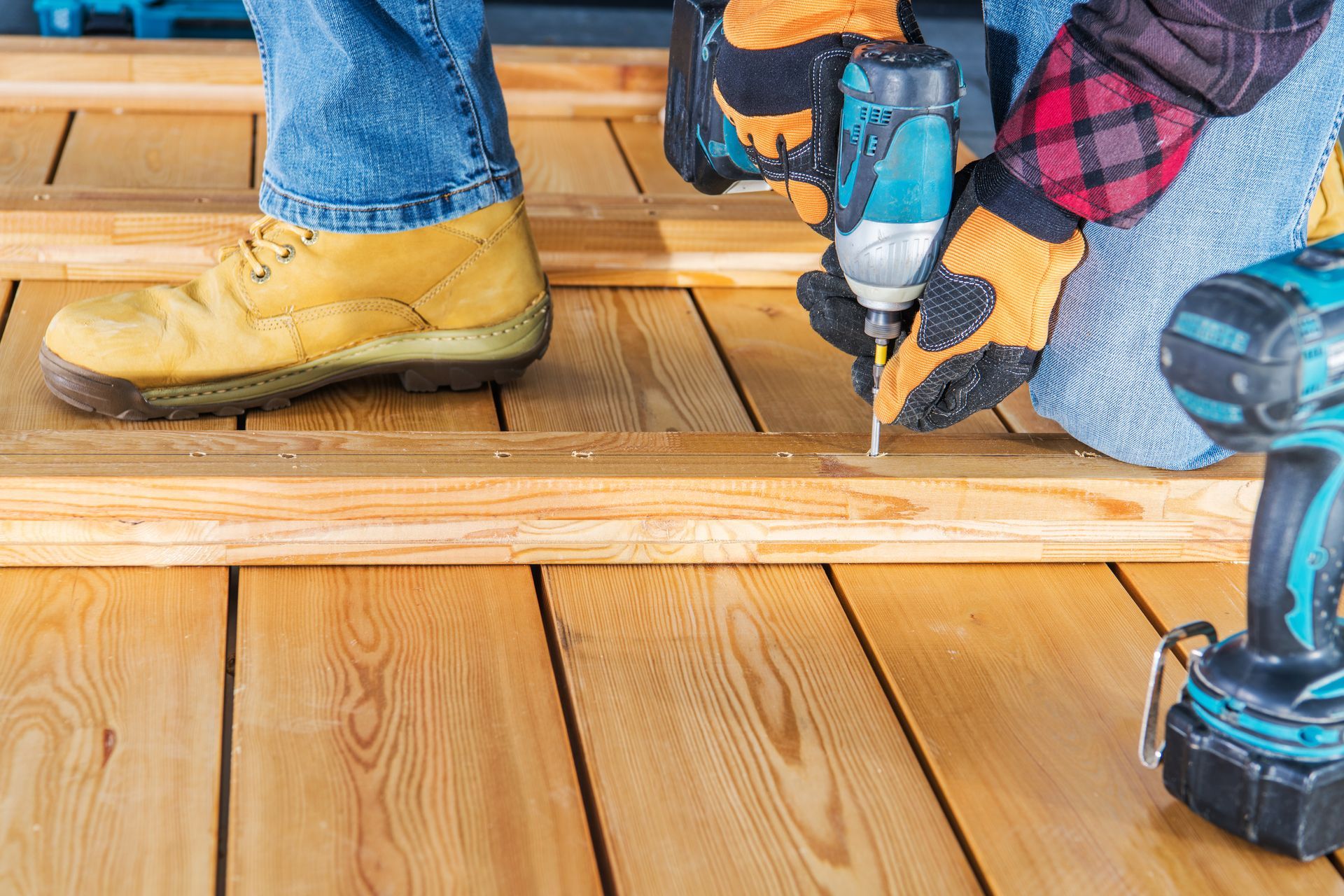 worker fixing deck with tools in western NY