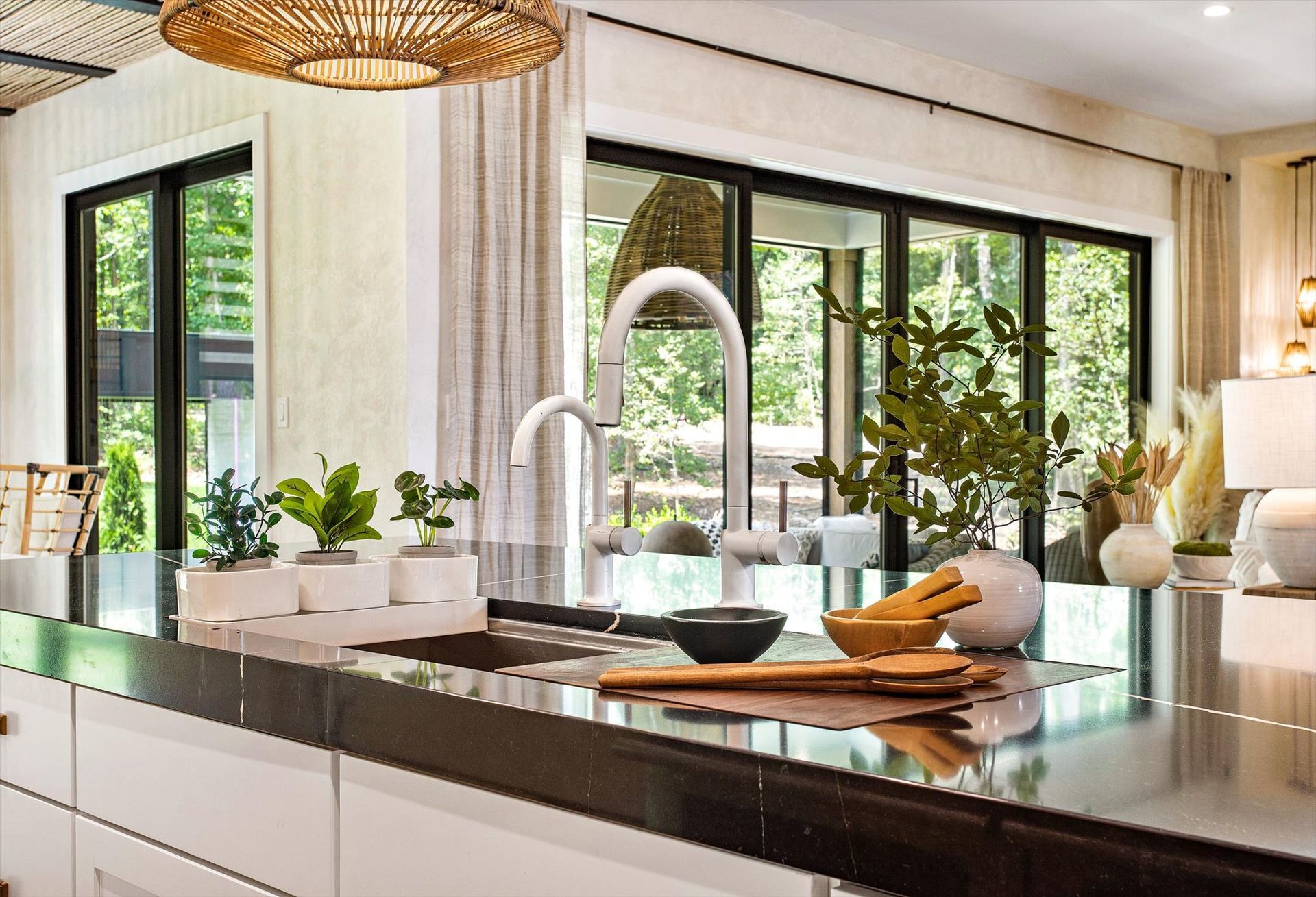 A kitchen with a sink and a large window.