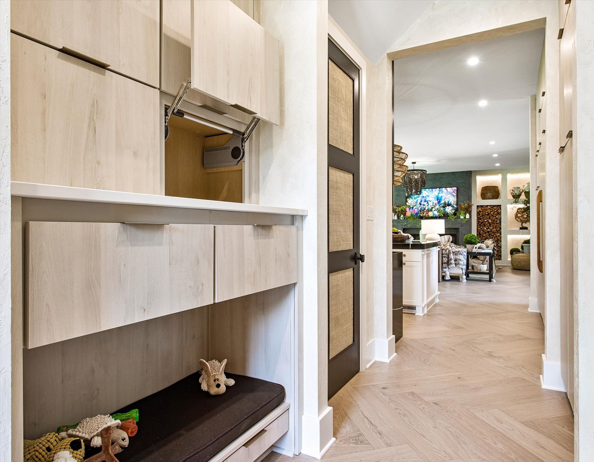 A hallway in a house with a bench and drawers.