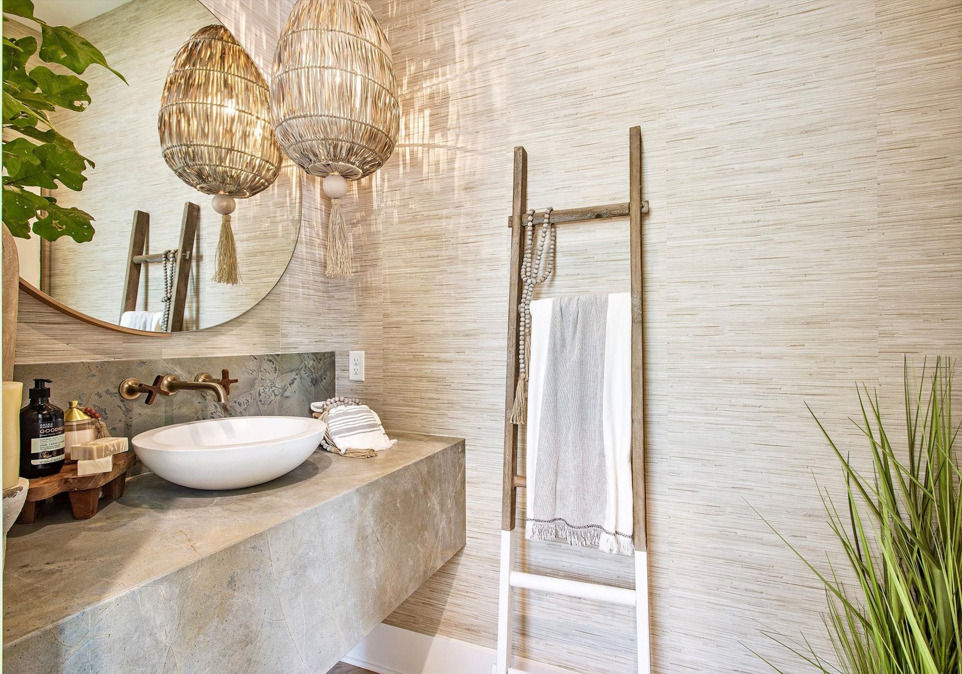 A bathroom with a sink , mirror , and towel rack.