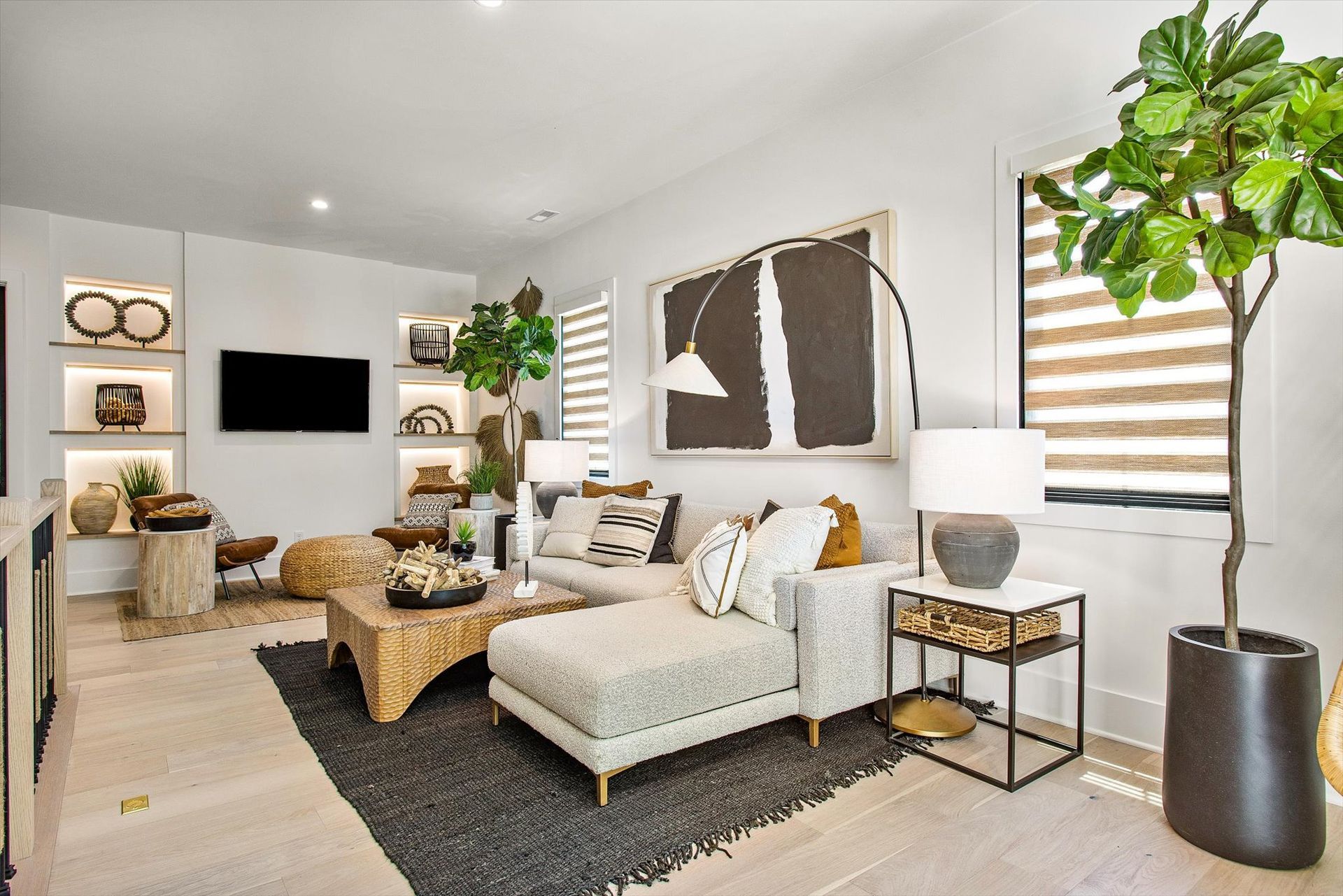 A living room with a couch , chairs , coffee table , and television.