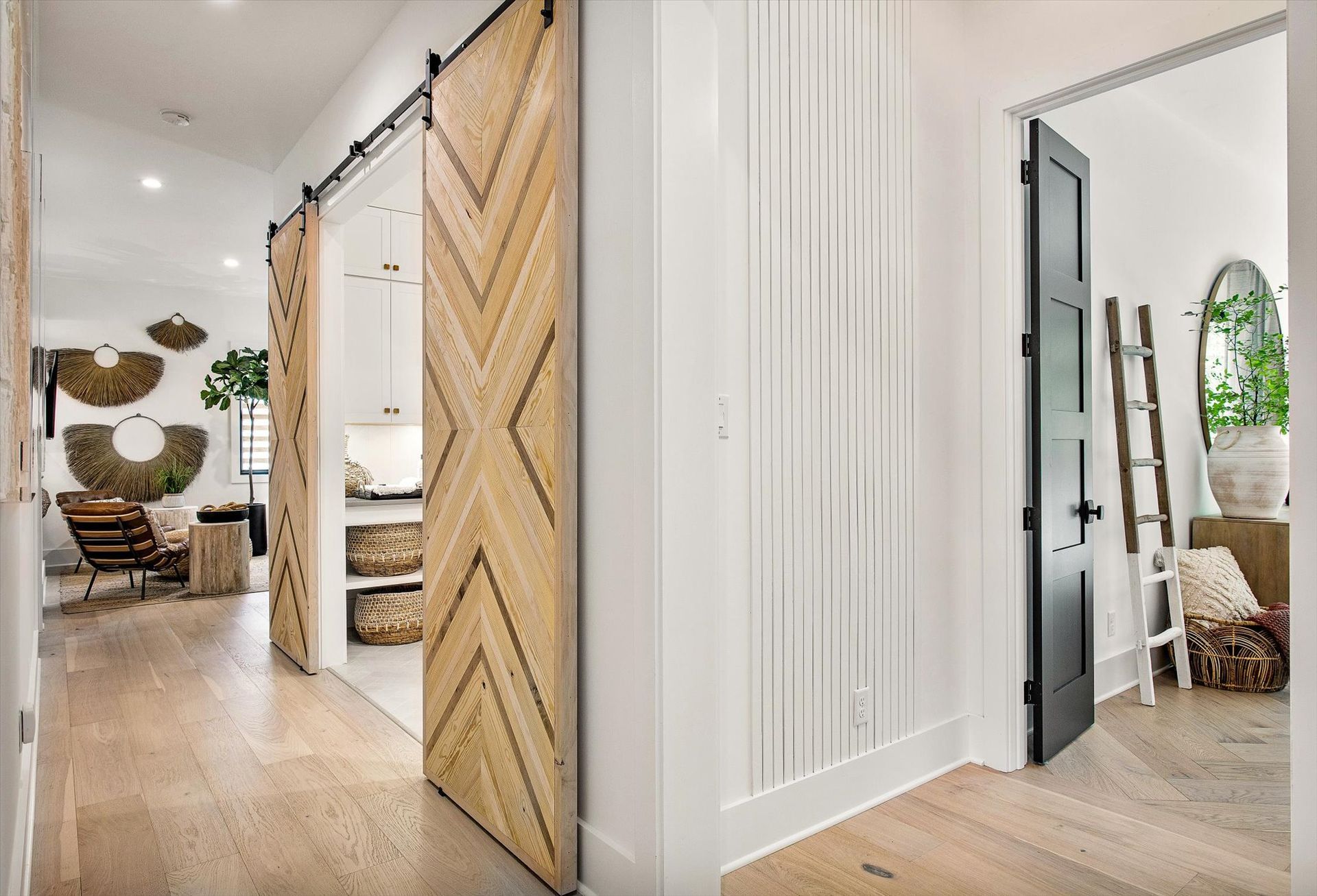 A hallway with sliding barn doors leading to a living room.