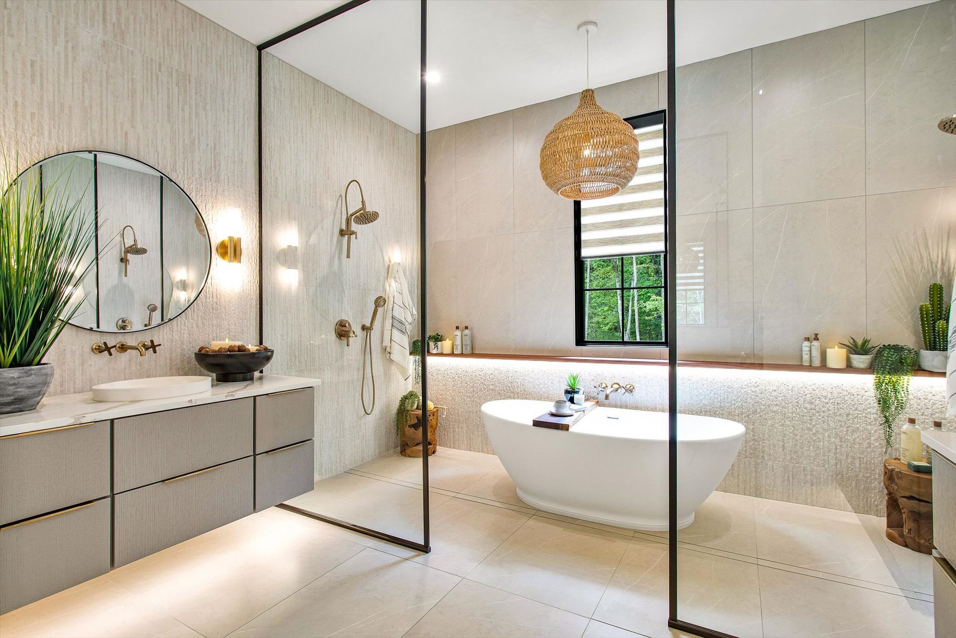 A bathroom with a tub , sink , mirror and shower.