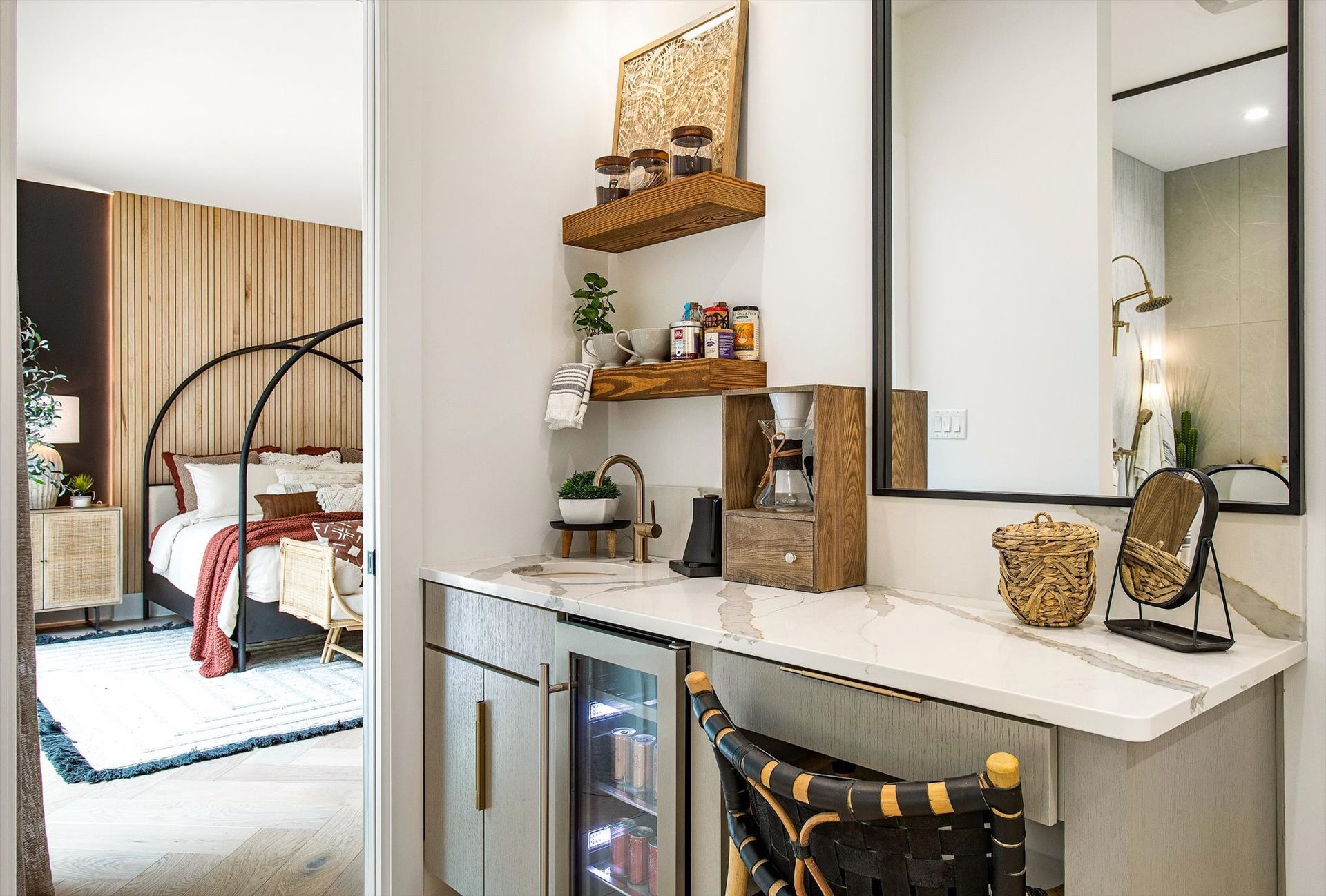 A bathroom with a sink , mirror , and refrigerator.