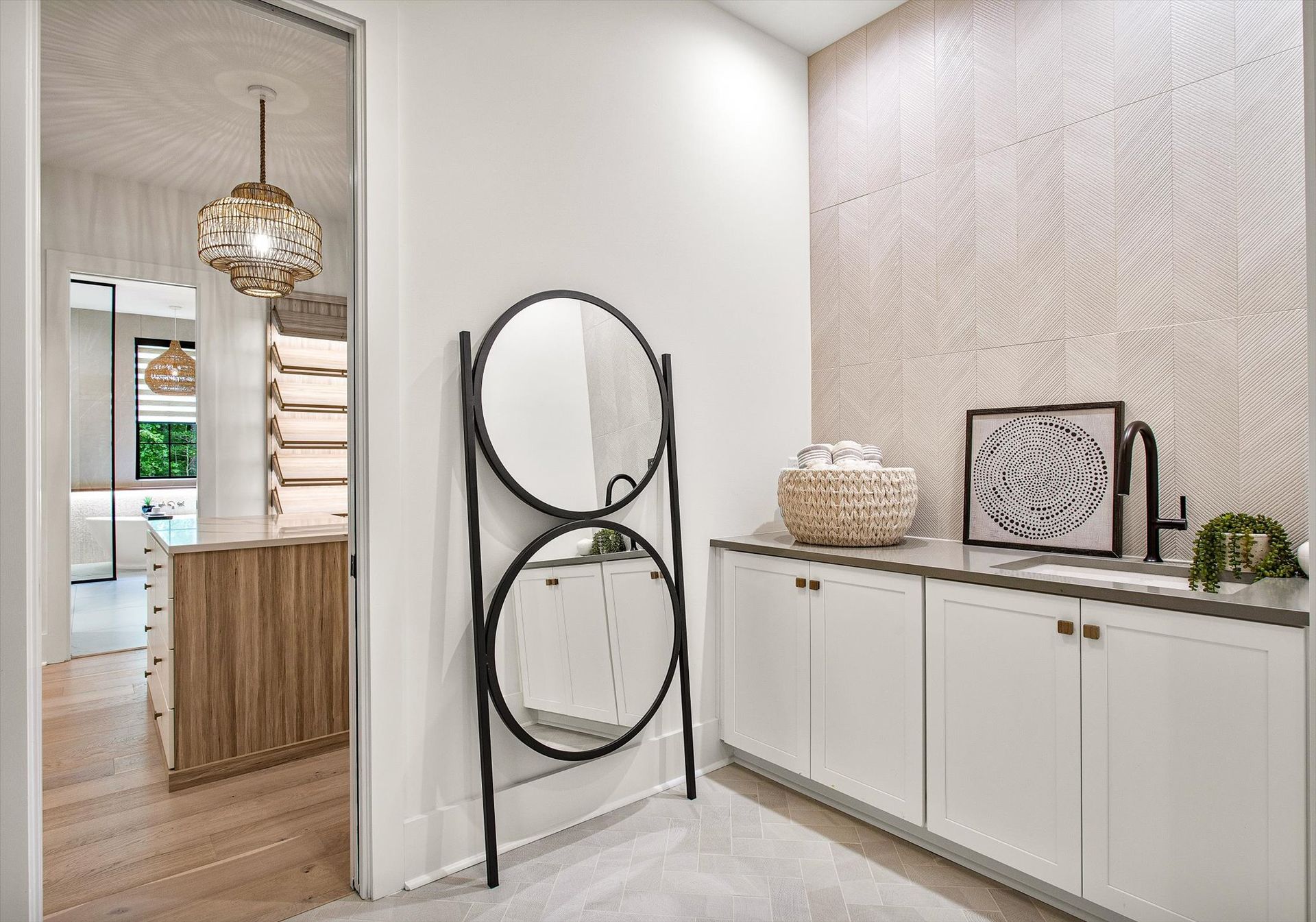 There is a large mirror on the wall in the hallway.