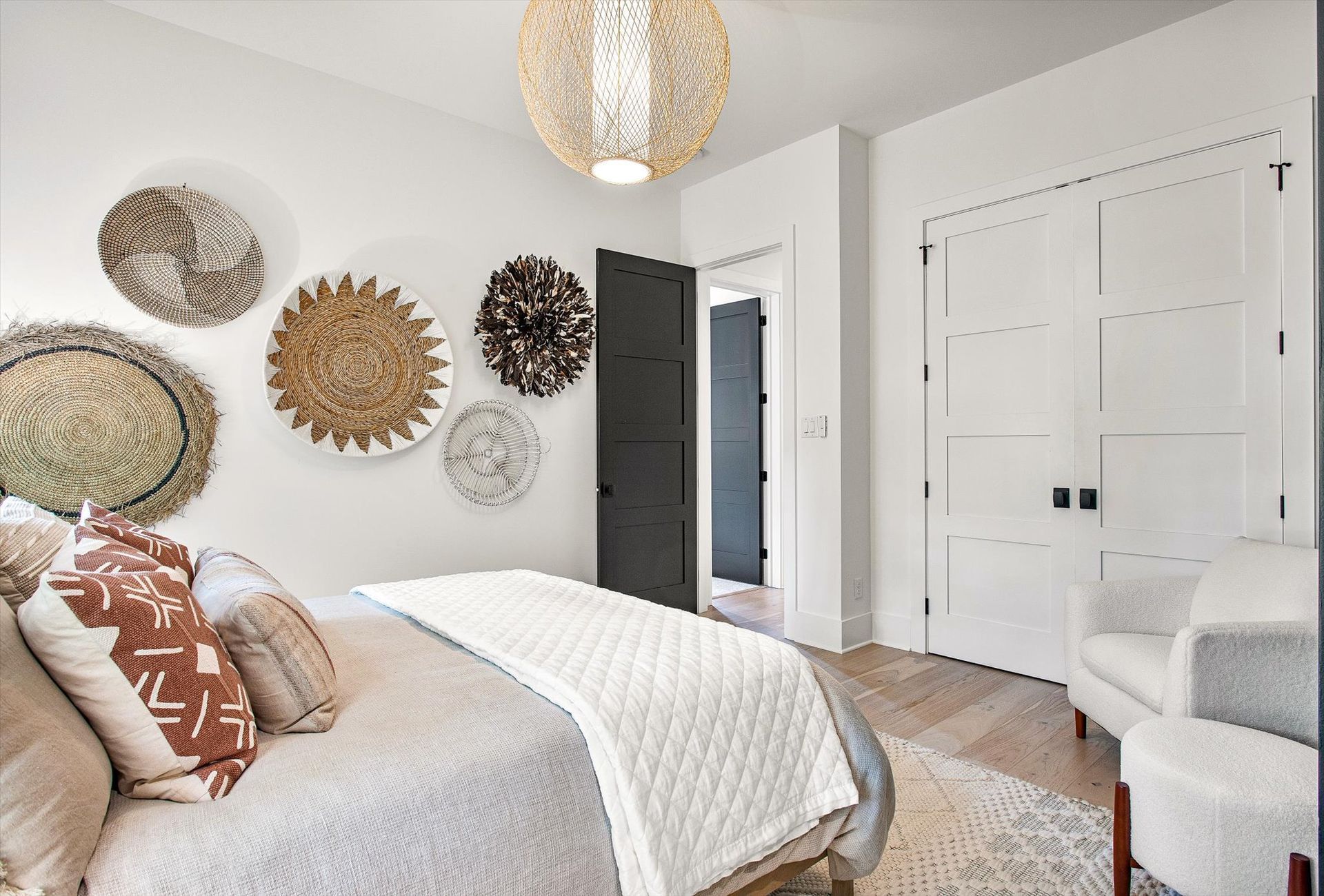 A bedroom with a bed , chair , and a closet.