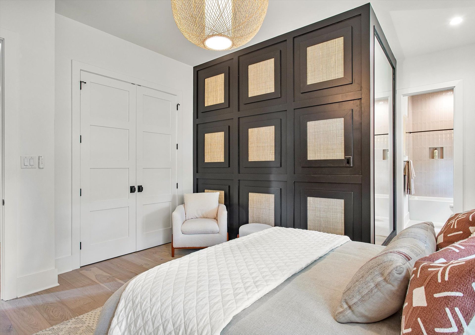 A bedroom with a bed , chair , and closet.