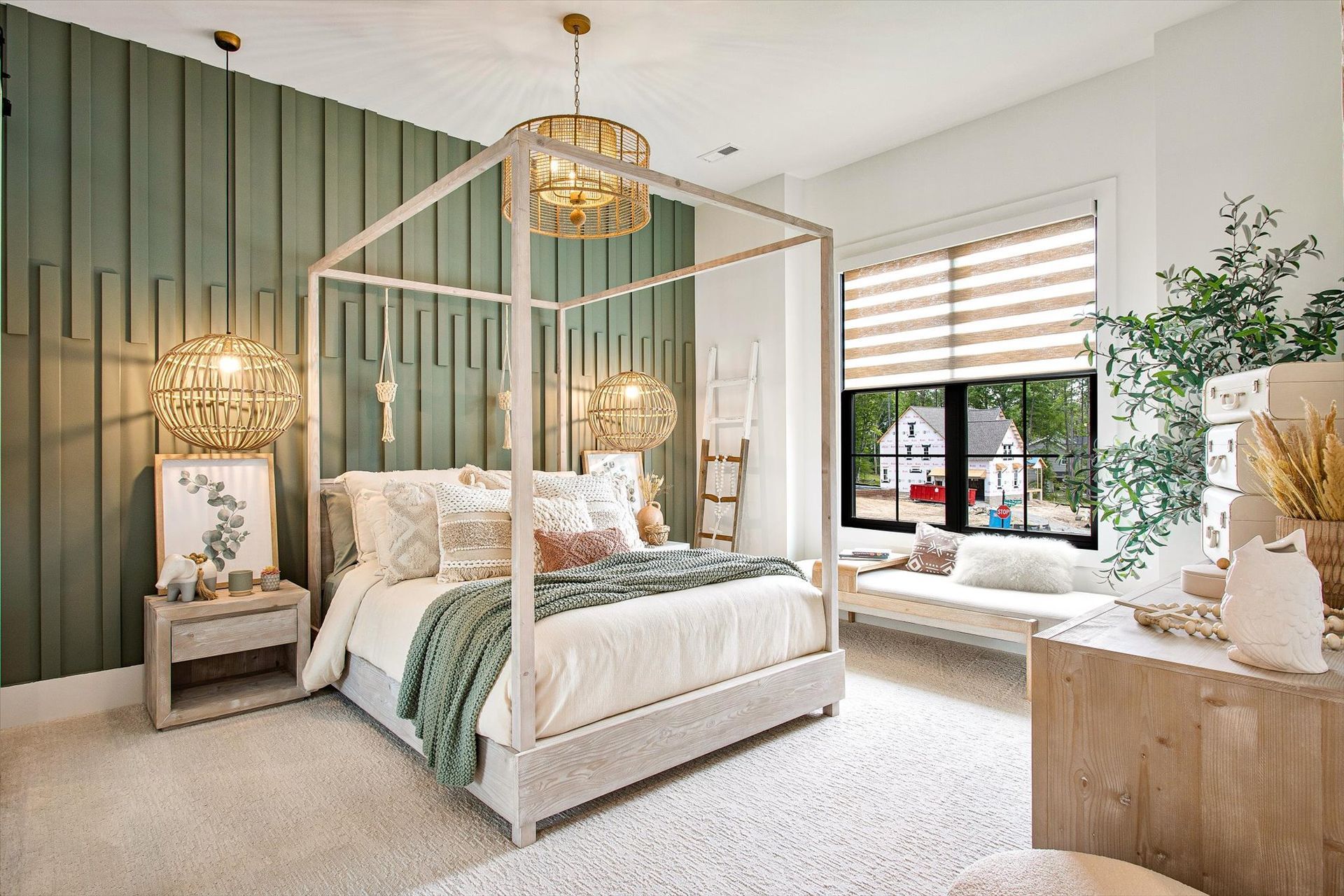 A bedroom with a canopy bed and a window.