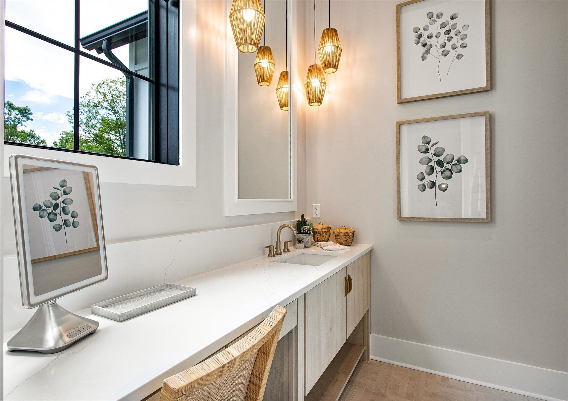 There is a desk with a computer on it in the corner of the room.