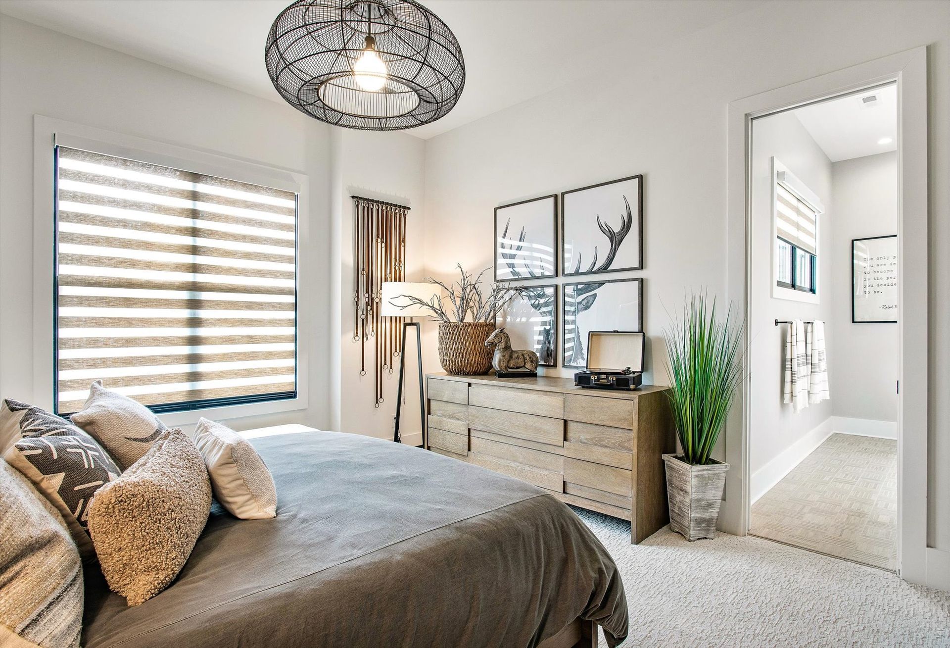 A bedroom with a bed , dresser , and window