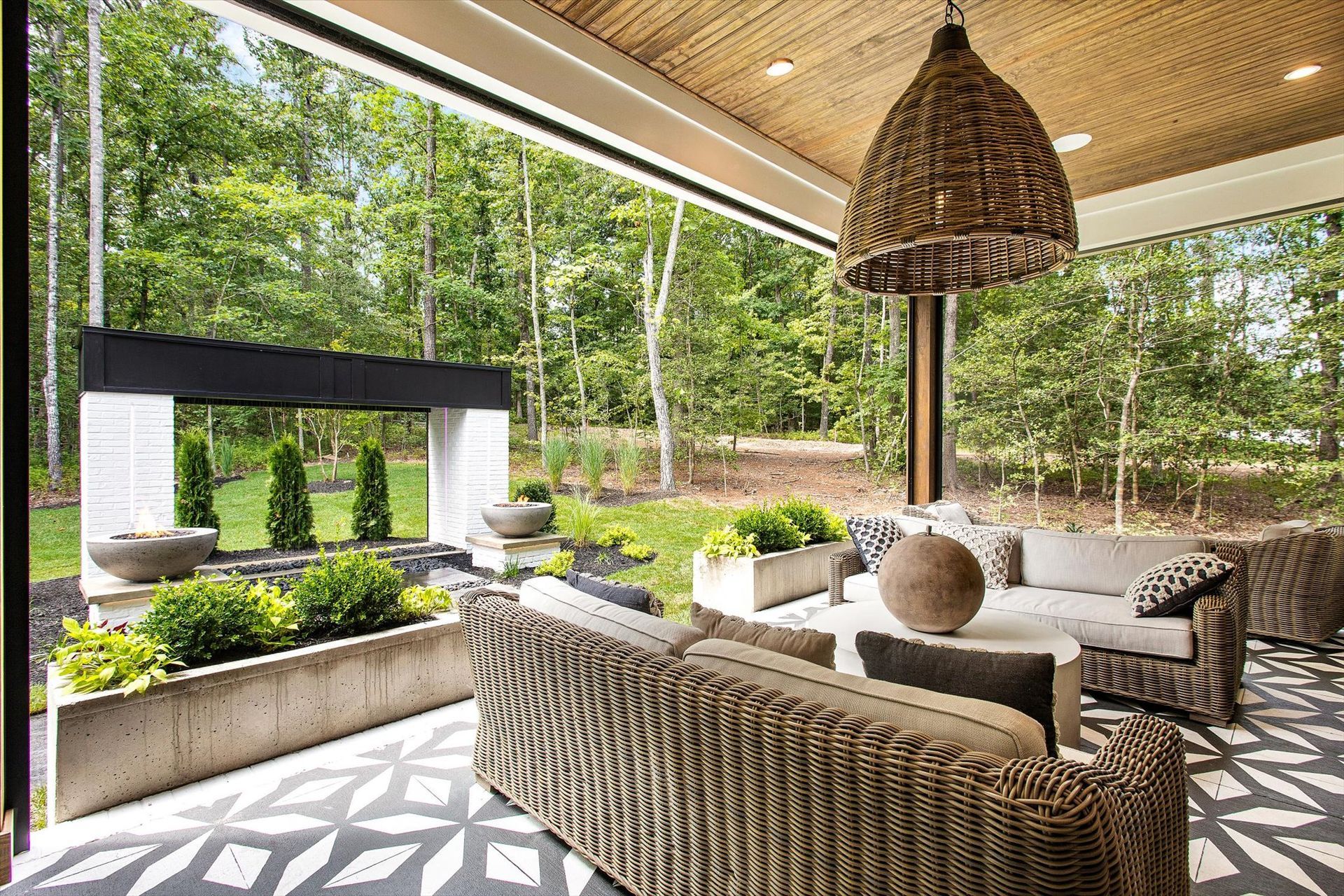 A living room with a couch , chairs , and a rug.