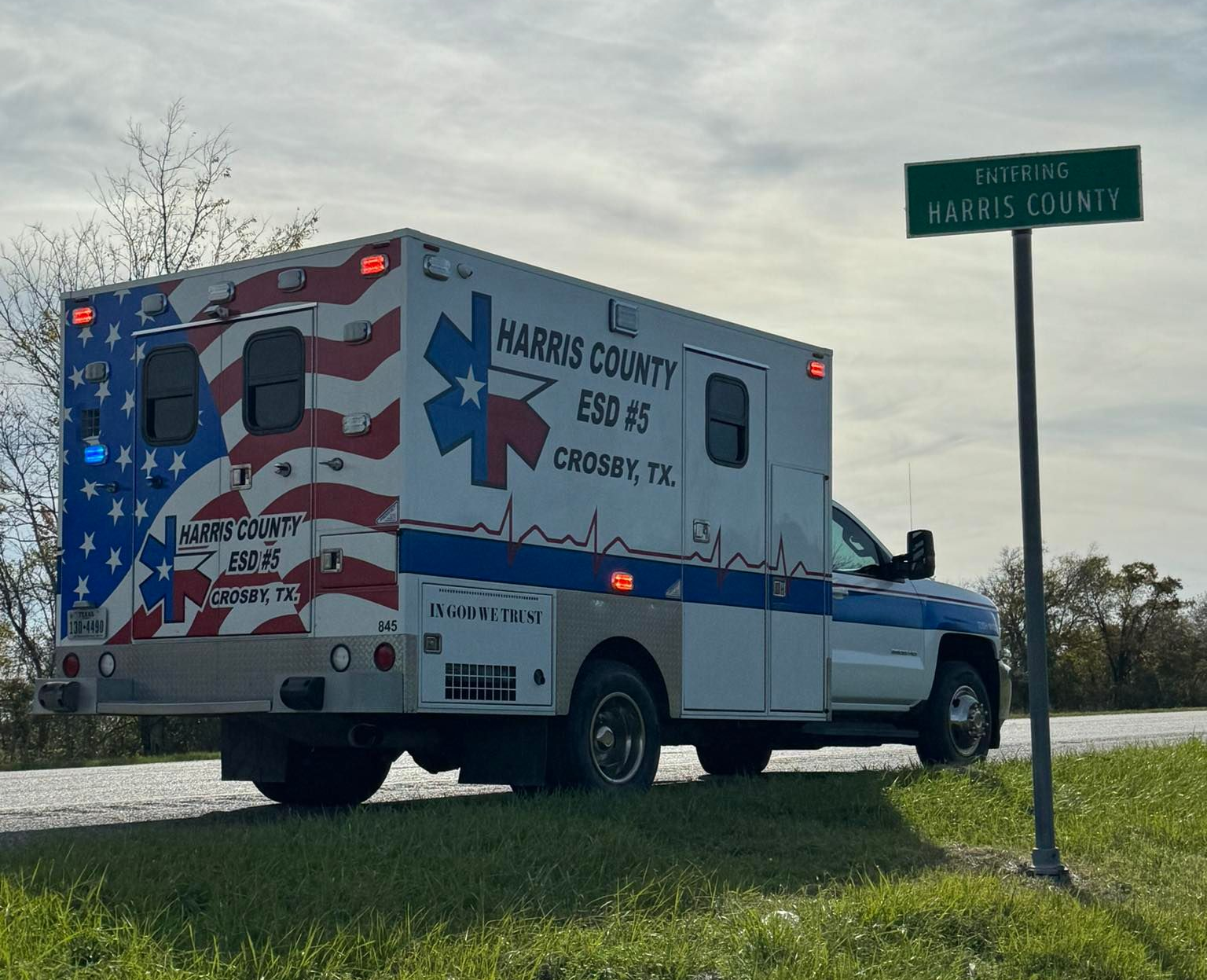 HCESD 5 Ambulance with American flag design, parked near a
