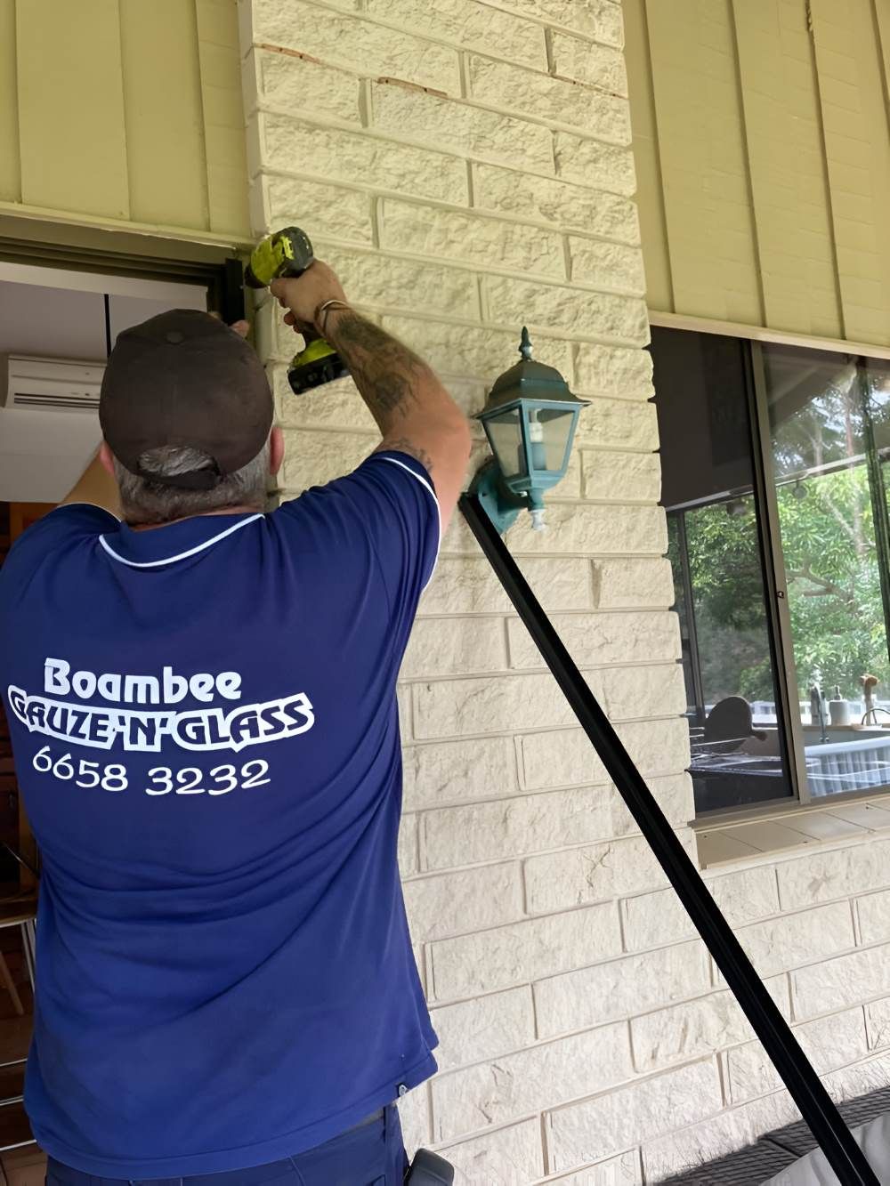 A Man Working on A Brick Wall — Boambee Gauze 'n' Glass in Harbour, NSW