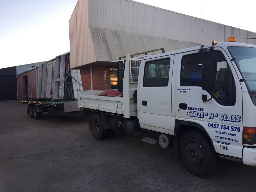 A White Truck with A Trailer Attached — Boambee Gauze 'n' Glass in Harbour, NSW