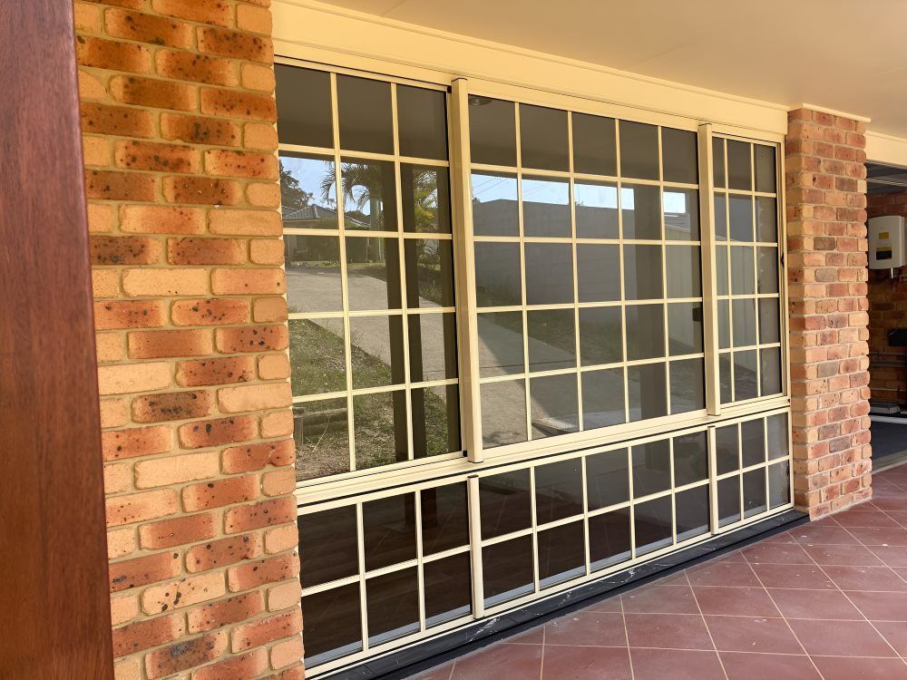 A Large Window with A Brick Wall Behind — Boambee Gauze 'n' Glass in Harbour, NSW