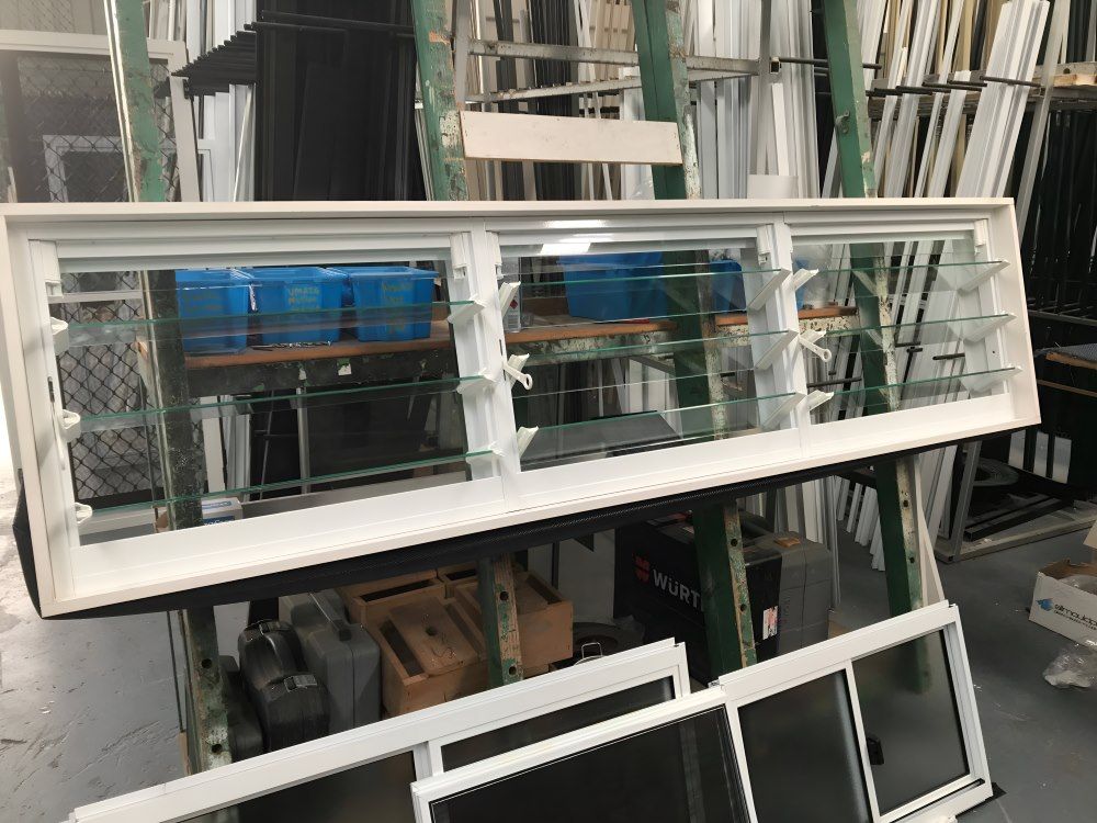 A Bunch of Windows Are Stacked — Boambee Gauze 'n' Glass in Harbour, NSW