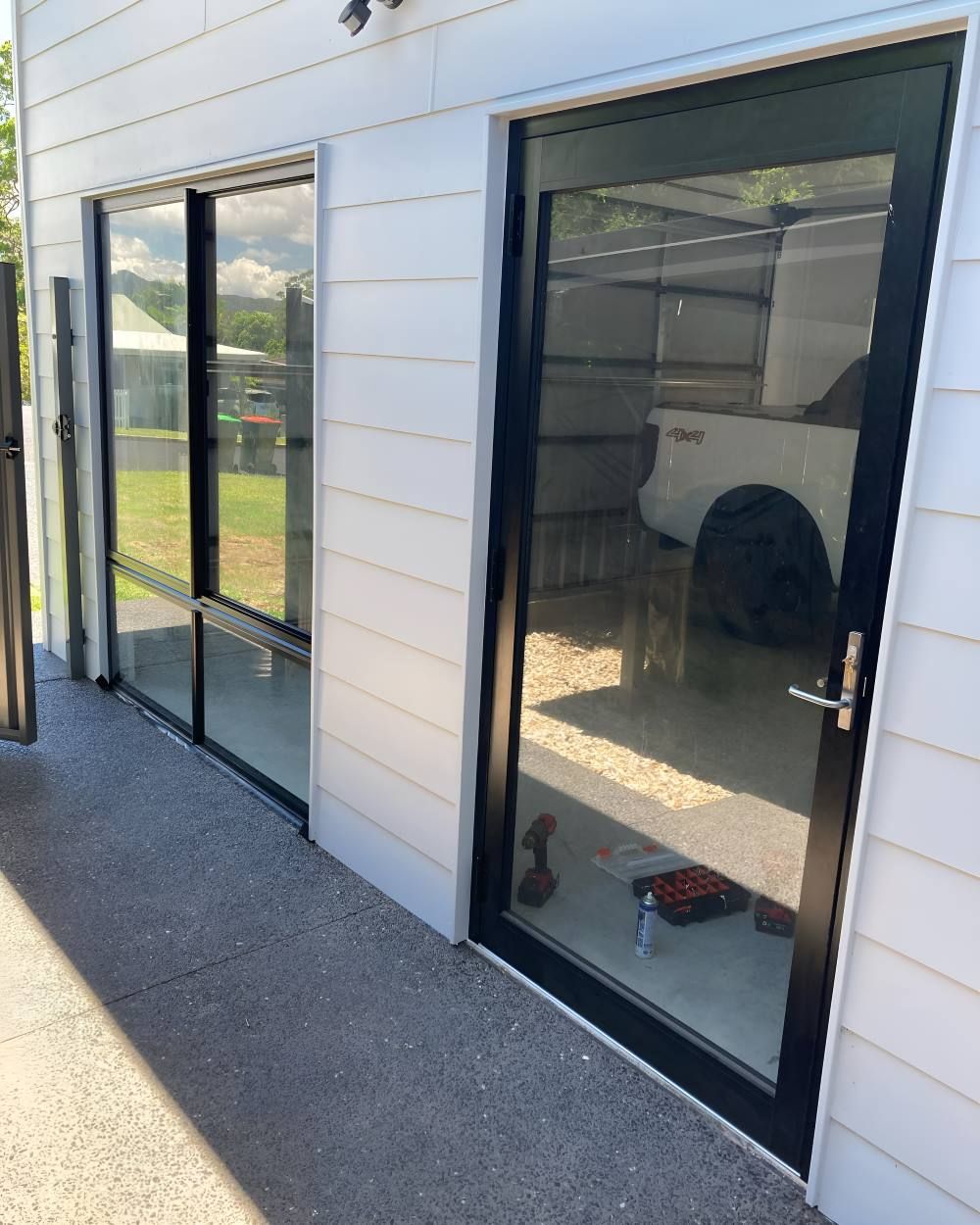 A White Truck Is Parked in Front of A Building — Boambee Gauze 'n' Glass in Harbour, NSW