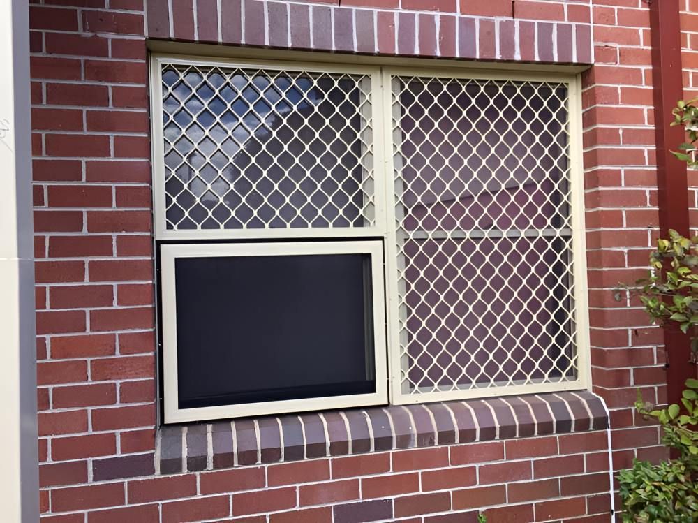 A Brick Building with A Window with A Screen on It — Boambee Gauze 'n' Glass in Harbour, NSW