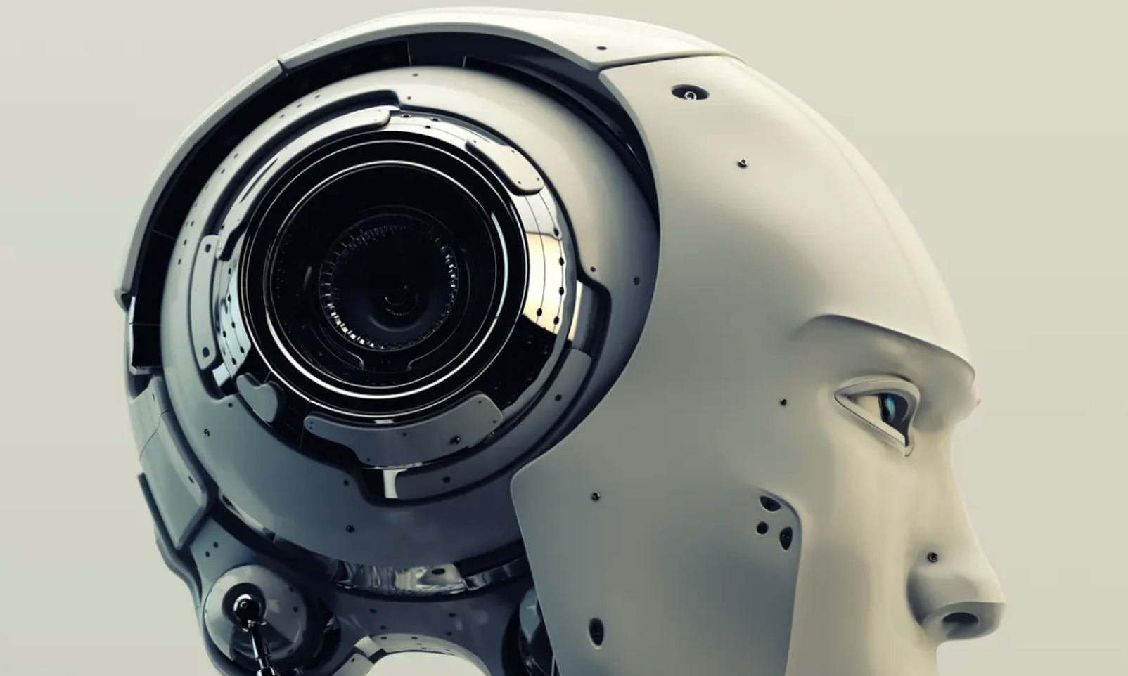 Close-up of a white, smooth-faced android head with a complex, mechanical camera lens replacing the left side of its skull.