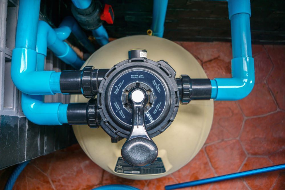 A Close Up of a Swimming Pool Filter With Blue Pipes Attached to It — Figleaf Pool Products in Casuarina, NT