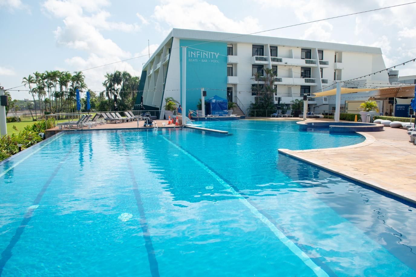 There Is a Large Swimming Pool in Front of A Hotel — Figleaf Pool Products in Coconut Grove, NT