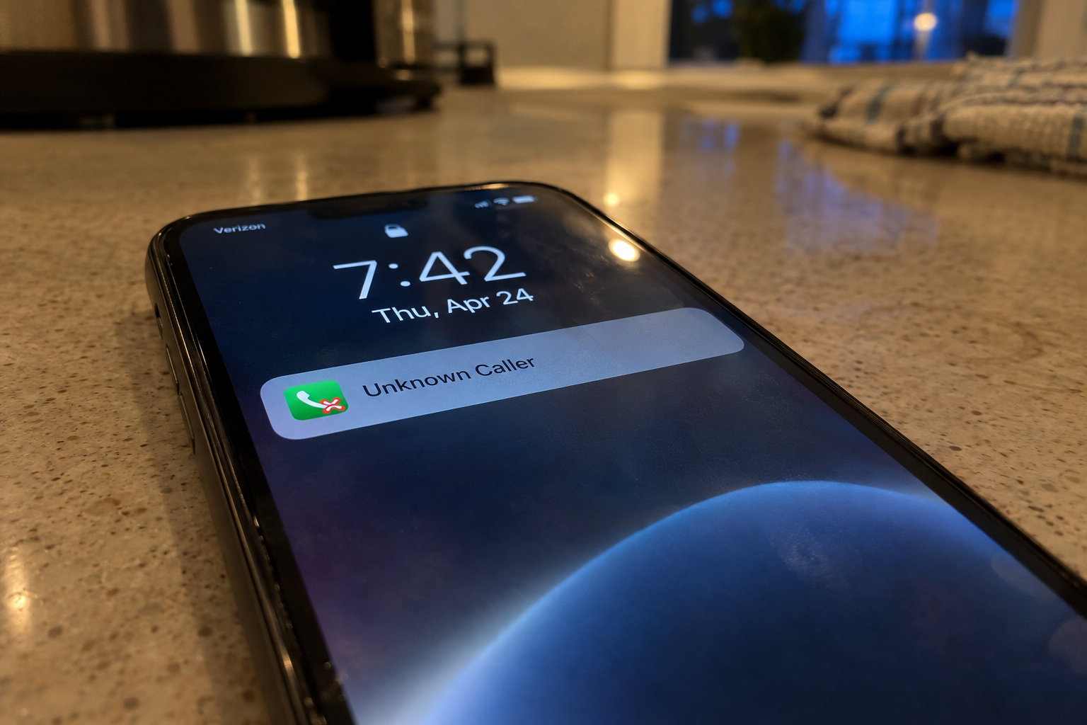 A smartphone showing a missed call from an unknown number on a kitchen counter