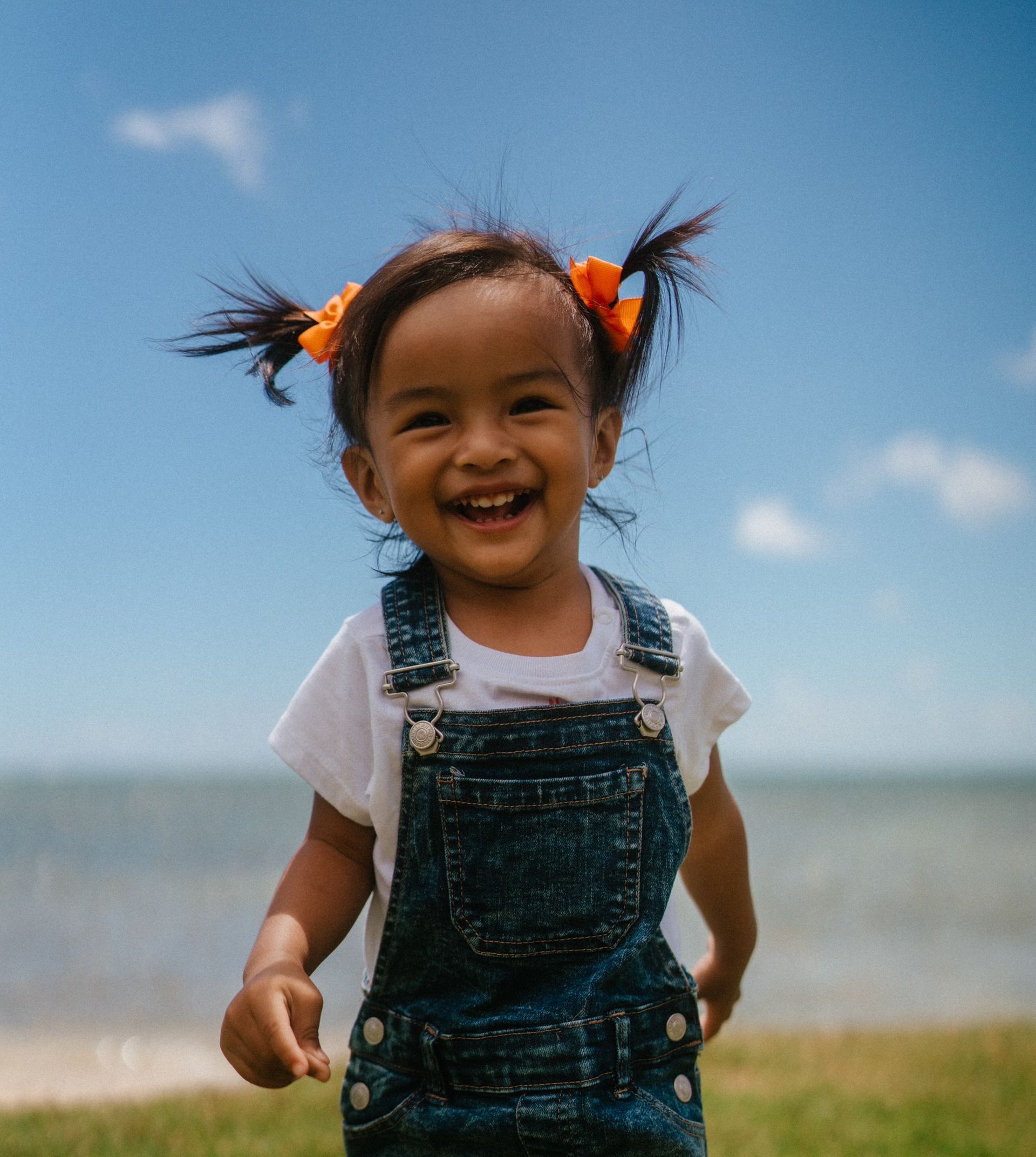 Young girl smiling on beach.
