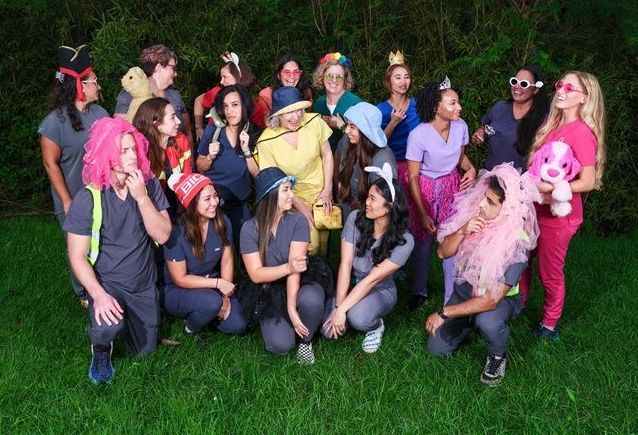 A group of people dressed in costumes are posing for a picture.