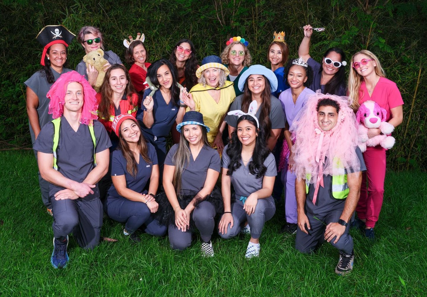 A group of people dressed in costumes are posing for a picture.