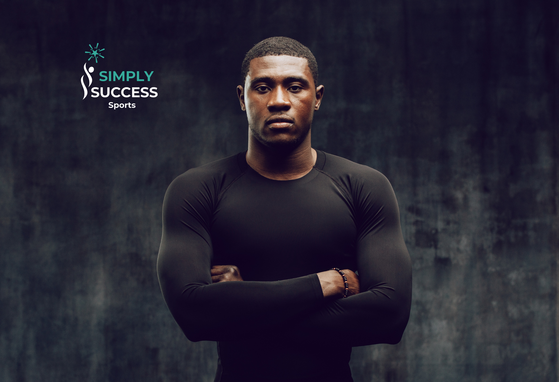 Man standing with arms crossed against a dark textured background, with “Simply Success” logo in the corner
