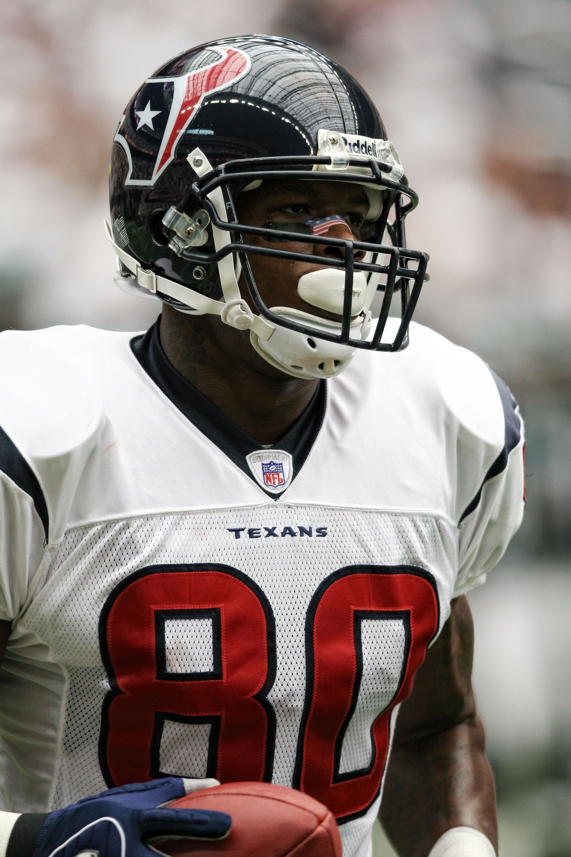Houston Texans football player in white jersey number 80 and black helmet on the field