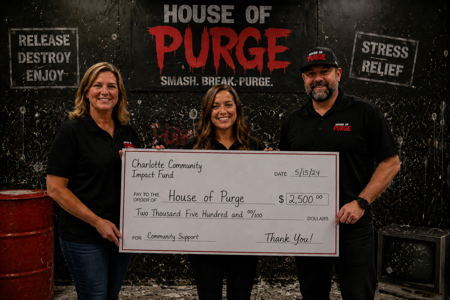 Two people holding a giant donation check in front of a House of Purge smash room sign.