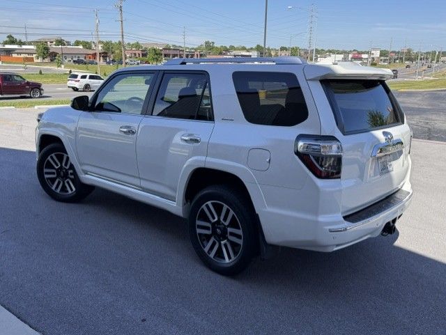 White SUV parked on a sunny roadside with tinted windows and black trim